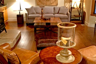 Example of a large mountain style open concept dark wood floor living room design in San Francisco with a wood stove
