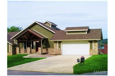 Inspiration for a rustic green two-story mixed siding exterior home remodel in Other