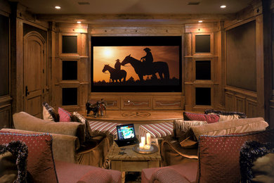 Large island style enclosed carpeted home theater photo in San Diego with beige walls and a projector screen