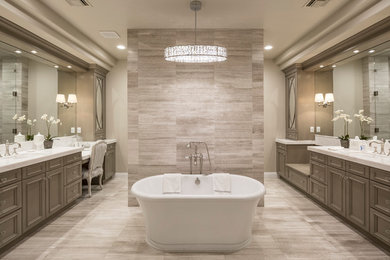 Large trendy master porcelain tile and beige floor freestanding bathtub photo in Phoenix with recessed-panel cabinets, medium tone wood cabinets, beige walls, an undermount sink and solid surface countertops