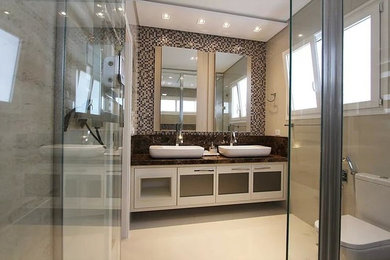 Mid-sized elegant master beige tile and porcelain tile ceramic tile bathroom photo in Boston with white cabinets, a two-piece toilet, beige walls, a vessel sink, granite countertops, a hinged shower door and brown countertops