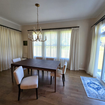 Pinch pleated drapery and sheers in dining roomm