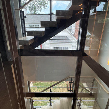 Project #136 | Modern Floating Staircase Encircling Glass Elevator