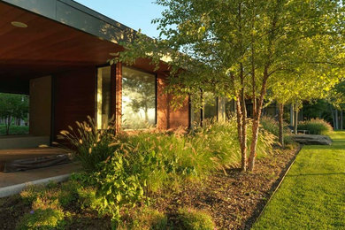 Design ideas for a mid-sized transitional partial sun front yard mulch landscaping in Burlington.
