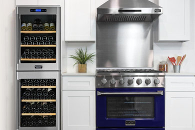Kitchen - contemporary kitchen idea in New York with metallic backsplash and stainless steel appliances