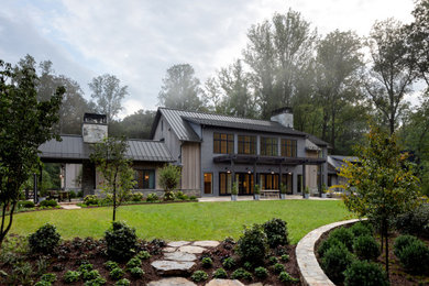 Huge country brown three-story mixed siding and clapboard exterior home photo in DC Metro with a metal roof and a gray roof