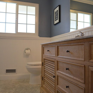 Foto de cuarto de baño infantil, de estilo americano, con lavabo encastrado, puertas de armario de madera clara, encimera de mármol, baldosas y/o azulejos blancos, paredes azules, suelo de mármol, bañera con patas, sanitario de una pieza y baldosas y/o azulejos de piedra