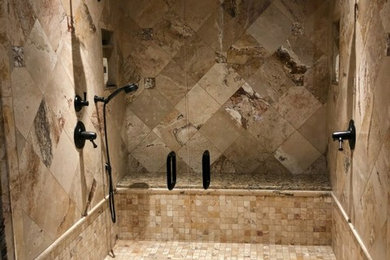 Example of a large classic master beige tile, brown tile and travertine tile travertine floor and brown floor alcove shower design in Other with brown walls and a hinged shower door