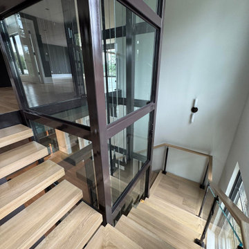 Project #136 | Modern Floating Staircase Encircling Glass Elevator