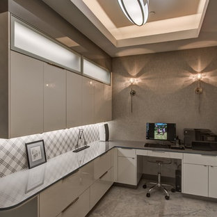 This is an example of a medium sized modern study in San Francisco with multi-coloured walls, marble flooring, no fireplace, a built-in desk and white floors.