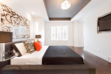 Large contemporary master bedroom in Calgary with white walls and dark hardwood floors.