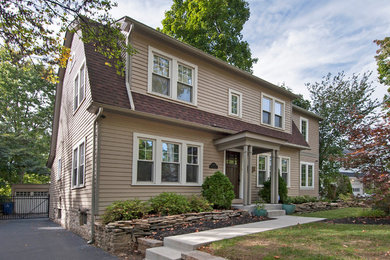 Traditional beige two-story concrete fiberboard house exterior idea in Columbus with a gambrel roof and a shingle roof