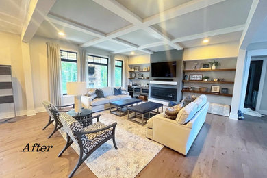 Example of a large trendy open concept light wood floor and coffered ceiling living room design in Cincinnati with gray walls and a standard fireplace