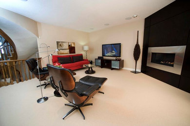Mid-sized trendy loft-style carpeted family room photo in Toronto with a metal fireplace, a wall-mounted tv, beige walls and a ribbon fireplace