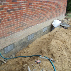 Foundation repair, retrofit by placing rebar and concrete in cores of block - Products