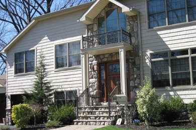This is an example of a mid-sized traditional full sun front yard concrete paver landscaping in New York.