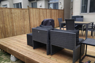 Example of a trendy backyard deck design in Ottawa