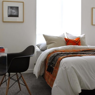 Modern Bedroom with Lucite Desk and Orange Kilim Pillow