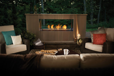 Inspiration for a mid-sized contemporary backyard patio remodel in Toronto with a fire pit and a roof extension