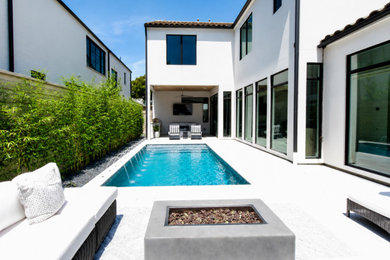 Pool - modern backyard stone and rectangular pool idea in Dallas