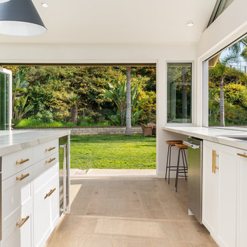 AG BiFold Patio Door & Window Pairing Connects All-White Kitchen to the Outdoors