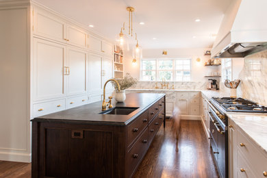 Inspiration for a timeless eat-in kitchen remodel in Portland with beaded inset cabinets, marble countertops, marble backsplash and an island