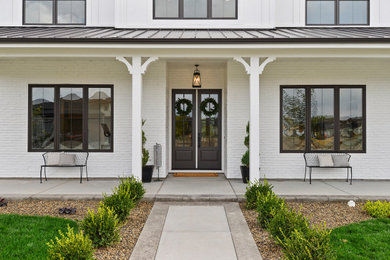 Large country white two-story mixed siding house exterior idea in Boise with a shed roof and a mixed material roof