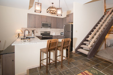 Example of a mid-sized minimalist u-shaped terra-cotta tile and brown floor open concept kitchen design in Denver with a double-bowl sink, recessed-panel cabinets, medium tone wood cabinets, marble countertops, beige backsplash, subway tile backsplash, stainless steel appliances and a peninsula