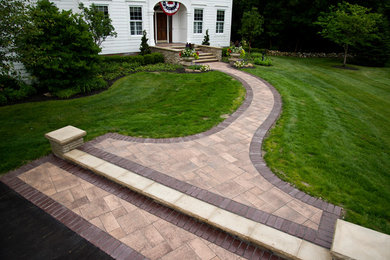 Photo of a mid-sized traditional full sun front yard concrete paver garden path in Indianapolis.