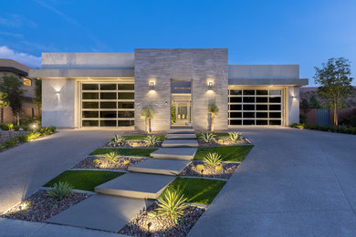 Photo of a mid-sized contemporary one-storey grey exterior in Las Vegas with stone veneer and a flat roof.
