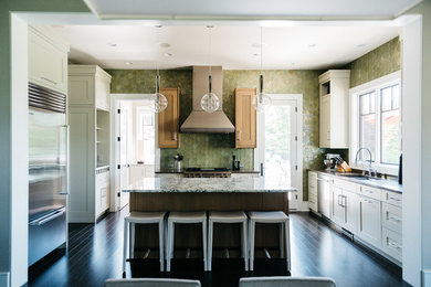 Photo of a transitional kitchen in Grand Rapids with a double-bowl sink, shaker cabinets, white cabinets, green splashback, stainless steel appliances, dark hardwood floors, with island and grey benchtop.