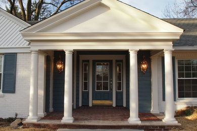 This is an example of a mid-sized traditional front yard verandah in Louisville with brick pavers and a roof extension.