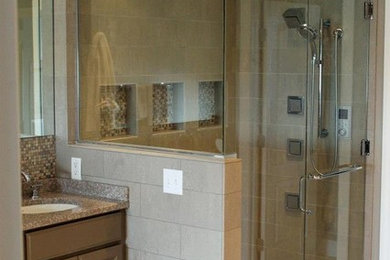 Corner shower - mid-sized transitional master brown tile and mosaic tile ceramic tile and beige floor corner shower idea in Chicago with raised-panel cabinets, brown cabinets, an undermount sink, granite countertops and a hinged shower door
