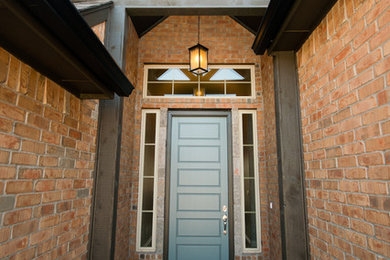 Example of a mid-sized transitional concrete floor entryway design in Oklahoma City with a blue front door