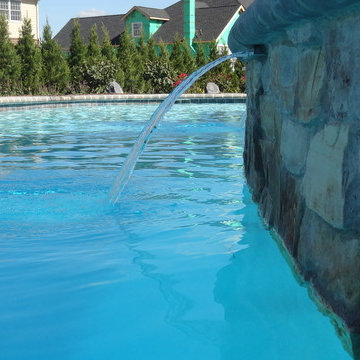 Freeform Pool with Raised Spillover Spa and Water Feature