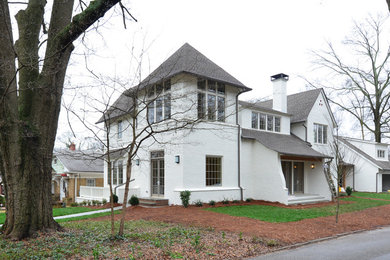 Large transitional white two-story brick exterior home idea in Atlanta