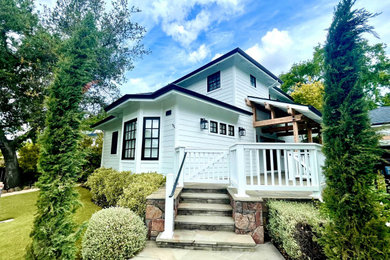 Mid-sized farmhouse white three-story wood and clapboard exterior home idea in San Francisco with a tile roof and a black roof