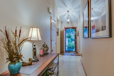 Small elegant ceramic tile entryway photo in Other with beige walls