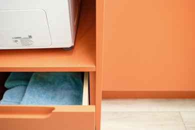 Inspiration for a small eclectic laundry closet remodel in Edmonton with an utility sink, flat-panel cabinets, quartz countertops, blue backsplash, mosaic tile backsplash, white walls, a stacked washer/dryer and white countertops