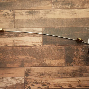 Curved Glass Wall Detail with Satin Brass Mounting Clips