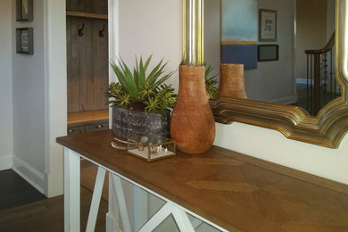 Example of a large transitional medium tone wood floor and gray floor foyer design in Other with beige walls