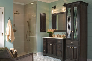 This is an example of a large traditional master bathroom in Minneapolis with raised-panel cabinets and dark wood cabinets.