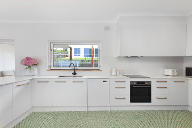 Photo of a mid-sized beach style galley separate kitchen in Adelaide with with island.