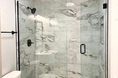 Inspiration for a mid-sized modern 3/4 multicolored tile and marble tile porcelain tile, gray floor and single-sink alcove shower remodel in Chicago with a one-piece toilet, multicolored walls, an integrated sink, granite countertops, a hinged shower door, white countertops, a freestanding vanity and white cabinets