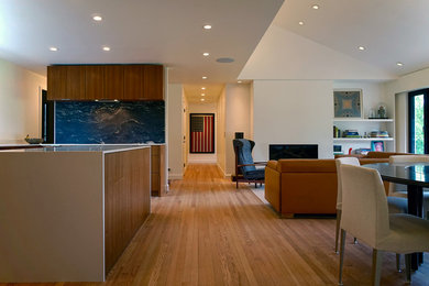 Mid-sized minimalist u-shaped medium tone wood floor and brown floor open concept kitchen photo in Kansas City with flat-panel cabinets, medium tone wood cabinets, quartz countertops, blue backsplash, stone slab backsplash and an island