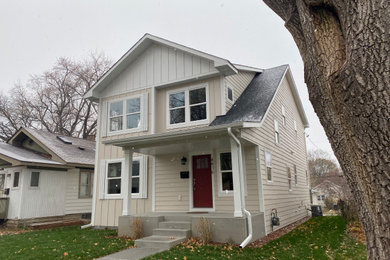 Small eclectic white two-story board and batten exterior home idea in Minneapolis