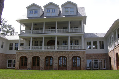 Example of a large 1960s white three-story wood gable roof design in Atlanta