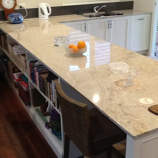 Mid-sized traditional kitchen pantry appliance - Inspiration for a mid-sized timeless galley kitchen pantry remodel in Newcastle - Maitland with beaded inset cabinets, white cabinets, marble countertops, gray backsplash, glass sheet backsplash, stainless steel appliances and an island