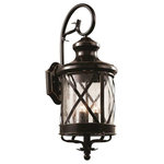Trans Globe Lighting - Chandler 23.25" Wall Lantern - The Chandler Collection exhibits a unique wall lantern that is perfect for adding supplemental lighting to any outdoor living space. The Traditional tone allows the lantern to stand out as both functional and decorative as it lights up any outdoor setting.  The Chandler 23.25" Wall Lantern is a three-light fixture with a clear Seeded Glass shade that creates soft reflections across the landscape.  A cross bar trim over the shade adds rustic appeal.  A decorative wall bracket with scroll arm suspends this classic coach style lantern.  The Chandler Collection is finished in Rubbed Oil Bronze.