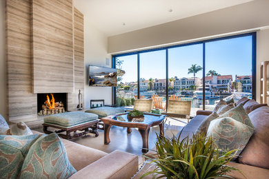 Living room - large contemporary open concept brown floor living room idea in Orange County with beige walls, a standard fireplace, a tile fireplace and a wall-mounted tv